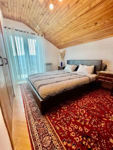 a bedroom with a large bed and a red rug at VILA MARTINA in Herceg-Novi