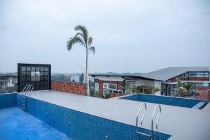a swimming pool on top of a building with a palm tree at HOTEL LAKE VIEW in Baharampur