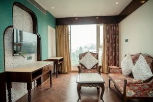 a living room with a couch and a mirror at HOTEL LAKE VIEW in Baharampur
