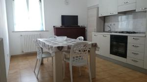 a kitchen with a table and chairs in a kitchen at STELLA appartamento in Policoro