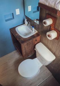 a bathroom with a white toilet and a sink at Casa Oaxaca in Oaxaca City