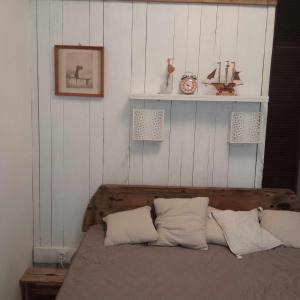 een slaapkamer met een bed met 2 kussens bij Hangulatos kis lakás a belvároshoz közel in Szeged