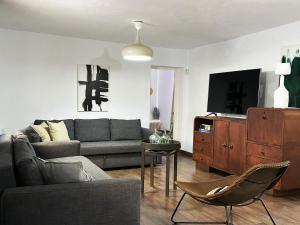a living room with a couch and a tv at ZAGV SPACE in Almería