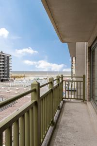 a balcony with a view of the beach at Tantor Nostalgie in Nieuwpoort