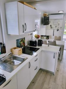 a kitchen with white cabinets and a sink and a counter at Floating Sea house MIRAMARE in Portorož
