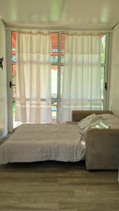 a bedroom with a bed and a large window at La Campigna, Neuquen in Plottier +13 photos