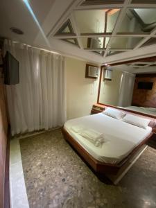 a bedroom with a large bed in a room at Megara in Rio de Janeiro +4 photos
