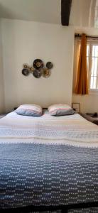a bed with two pillows on it in a bedroom at Le Cocon de Sisteron in Sisteron