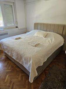 a bed with two towels on it in a bedroom at Apartment Luce in Split