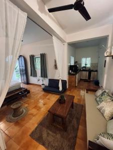 a living room with a couch and a table at Bayou Homestay and backwaters in Goa