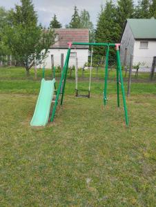 a couple of swings in a yard at Aliz és Martin vendégház in Balatonmáriafürdő