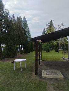 a bench and a table in a park at Aliz és Martin vendégház in Balatonmáriafürdő
