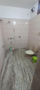 a dirty bathroom with a toilet and a sink at Green Heaven Kumarakom in Kumarakom