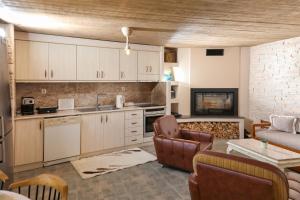 a kitchen and living room with a couch and a table at Hill House in Kavála