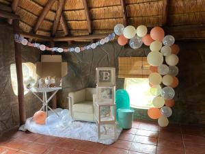 a room with a balloon garland and a room with a table at Horizon Garden Party & Events Venue in Randfontein