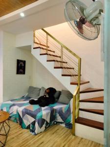 a room with a bed and a staircase at Ellie's Home Staycation in Palapala