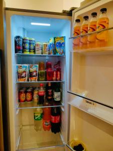 an open refrigerator filled with drinks and drinks at Ellie's Home Staycation in Palapala