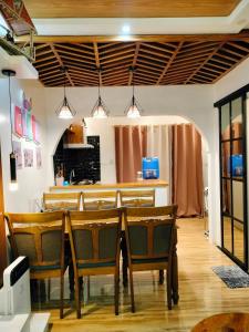 a dining room with a table and chairs at Ellie's Home Staycation in Palapala