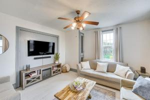 a living room with a couch and a flat screen tv at Charming Dutch Country River Haven Home with Deck 