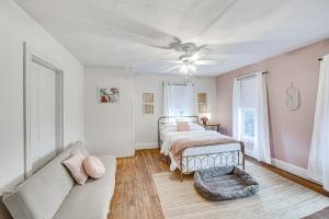 a bedroom with a bed and a couch at Charming Dutch Country River Haven Home with Deck 