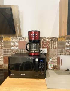 a coffee pot sitting on top of a microwave at NOUVEAU Maison Bourg Cournon 5 pers 2 chambres in Le Cendre