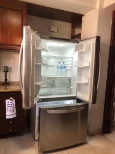 an empty refrigerator with its door open in a kitchen at santo domingo-avenida de españa in Santo Domingo
