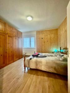 a bedroom with a large bed and wooden cabinets at Maggioni Silvia in Tarvisio