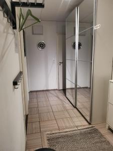a hallway with a walk in shower and a glass door at Boho Apart Ututie in Kotka