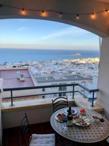 a balcony with a table and a view of a city at Apartamento de Carboneras - Terrazas y Vistas in Carboneras