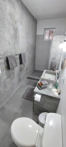 a bathroom with a white toilet and a sink at Chagres River Lodge 