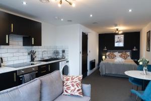 a kitchen and a bedroom with a bed in a room at Midsummer House Apartments "Free On-Site Parking & Sky TV" in Peterborough