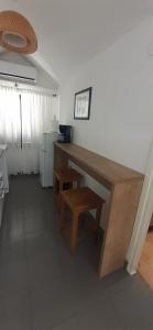 a kitchen with a wooden desk and a stool at Old Town Baska in Baška