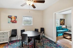 a living room with a dining room table and a couch at Chestnut St 3 Bedroom House in Historic Loveland in Loveland +12 photos