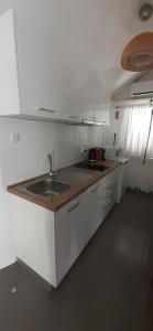 a kitchen with a sink and a counter top at Old Town Baska in Baška
