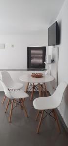 a white table and two white chairs in a room at Old Town Baska in Baška