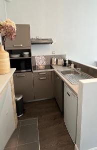 a kitchen with a sink and a counter top at Appartement de charme in Bayeux +19 photos
