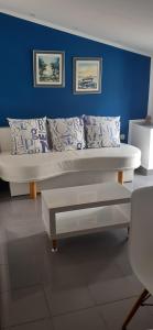a bed in a room with a blue wall at Old Town Baska in Baška