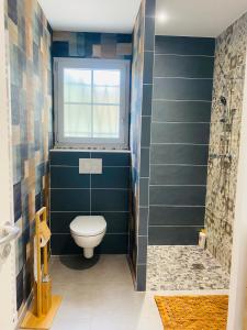 a bathroom with a toilet and a window at Le Saint Marin in Chatuzange-le-Goubet