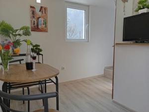 a living room with a table and a tv at Studio Biokovo smaller object 22 m2 in Makarska