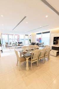 a large dining room with a table and chairs at Tiffany Beach in Durat  Alarous