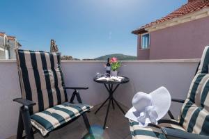 a pair of chairs and a table on a balcony at Apartments Lana in Mlini