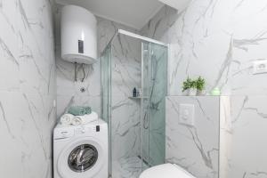 a bathroom with a washing machine and a shower at Apartments Lana in Mlini +35 photos