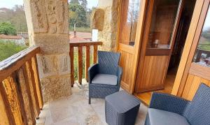 balcón con 2 sillas y puerta de madera en Habitación Deluxe Campomuiños, en Entrerríos