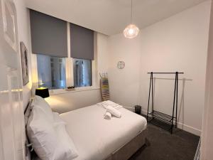Voodi või voodid majutusasutuse Liverpool Suites toas