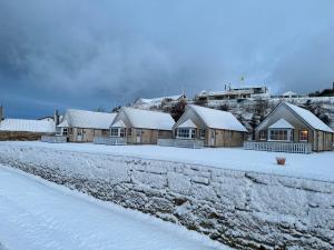 a row of houses with snow on the ground at Dolphin View Cottages 2 in Portmahomack