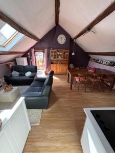un soggiorno con un divano e un tavolo di La Maison du bonheur - Gîte RULINA - Corancy a Corancy
