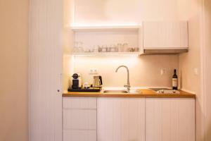 A kitchen or kitchenette at NESEA Boutique Apartments