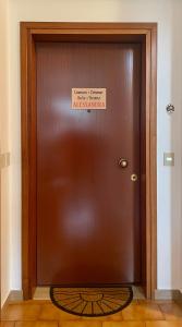 a brown door with a sign on it at Alessandra in Fusine in Valromana