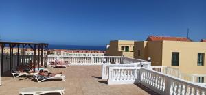 a group of people sitting in chairs on a balcony at PARAISO DE LUX in Costa de Antigua