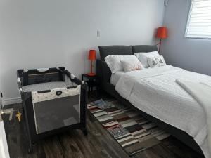 ein Schlafzimmer mit einem Bett und einem Tisch mit einer Lampe in der Unterkunft Refuge urbain à Beauport in Québec